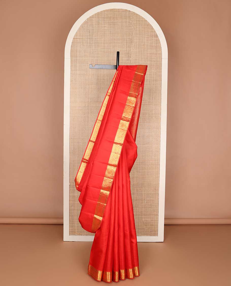 Red embossed design Parampara silk saree with self border of thilakam mokku, paun, mayil design & floral pallu