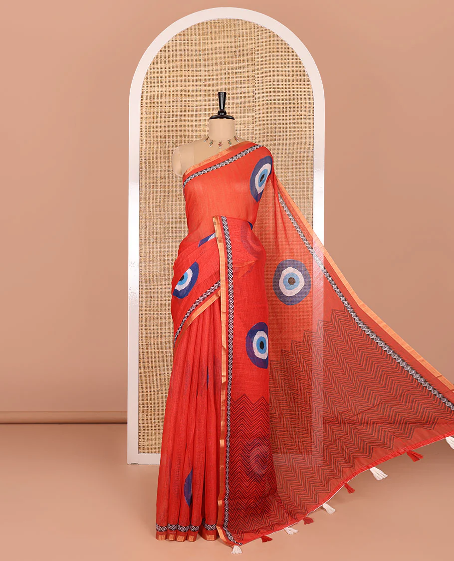 Red evil eye motifs printed linen cotton saree, diamond motifs printed with piping border, chevron printed pallu, and a matching blouse