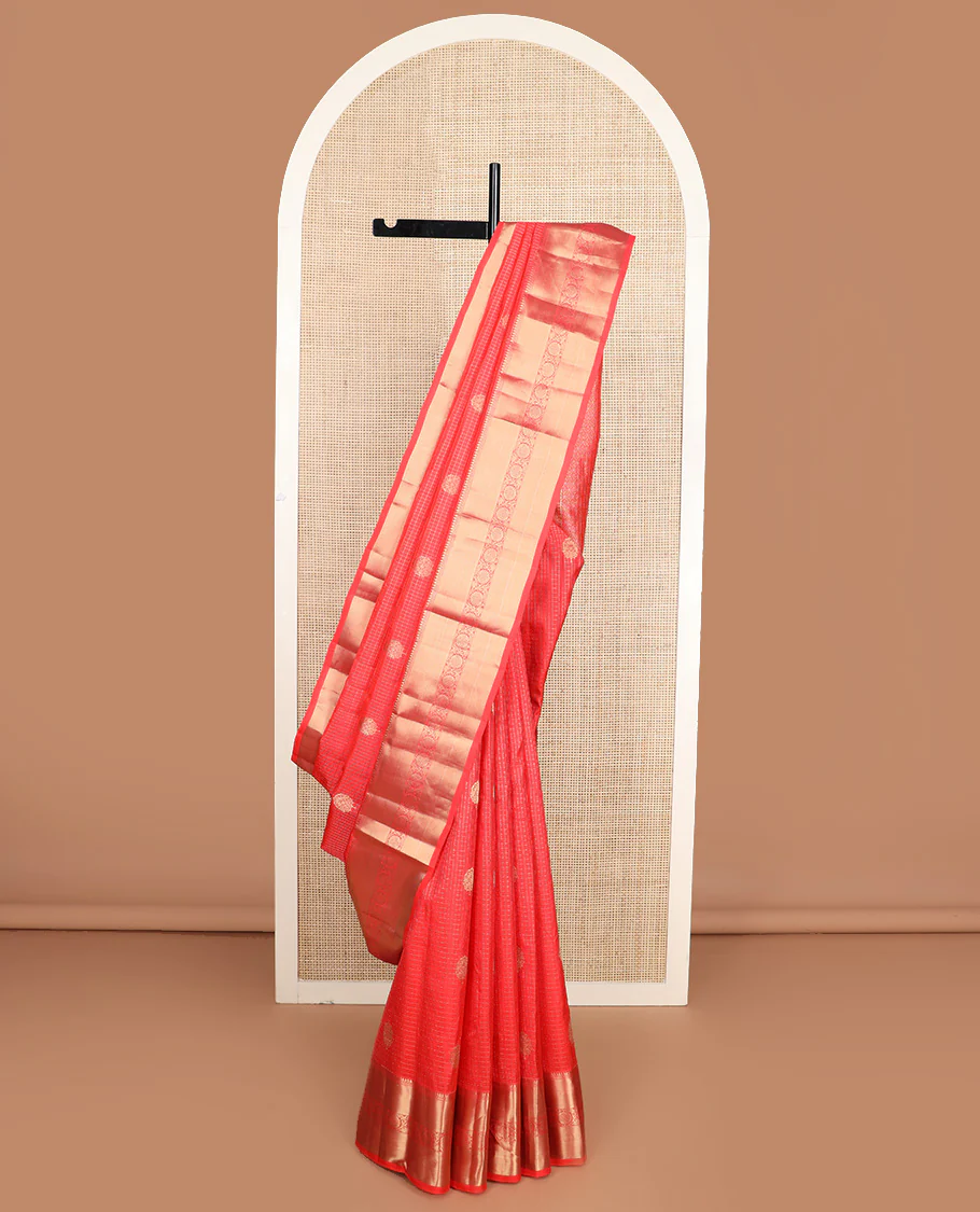 Red micro-checked and buttas Vasundhara silk saree, zari border of thilakam mokku, neli, zari stripes, and kodi visiry designs, and ogee patterned pallu