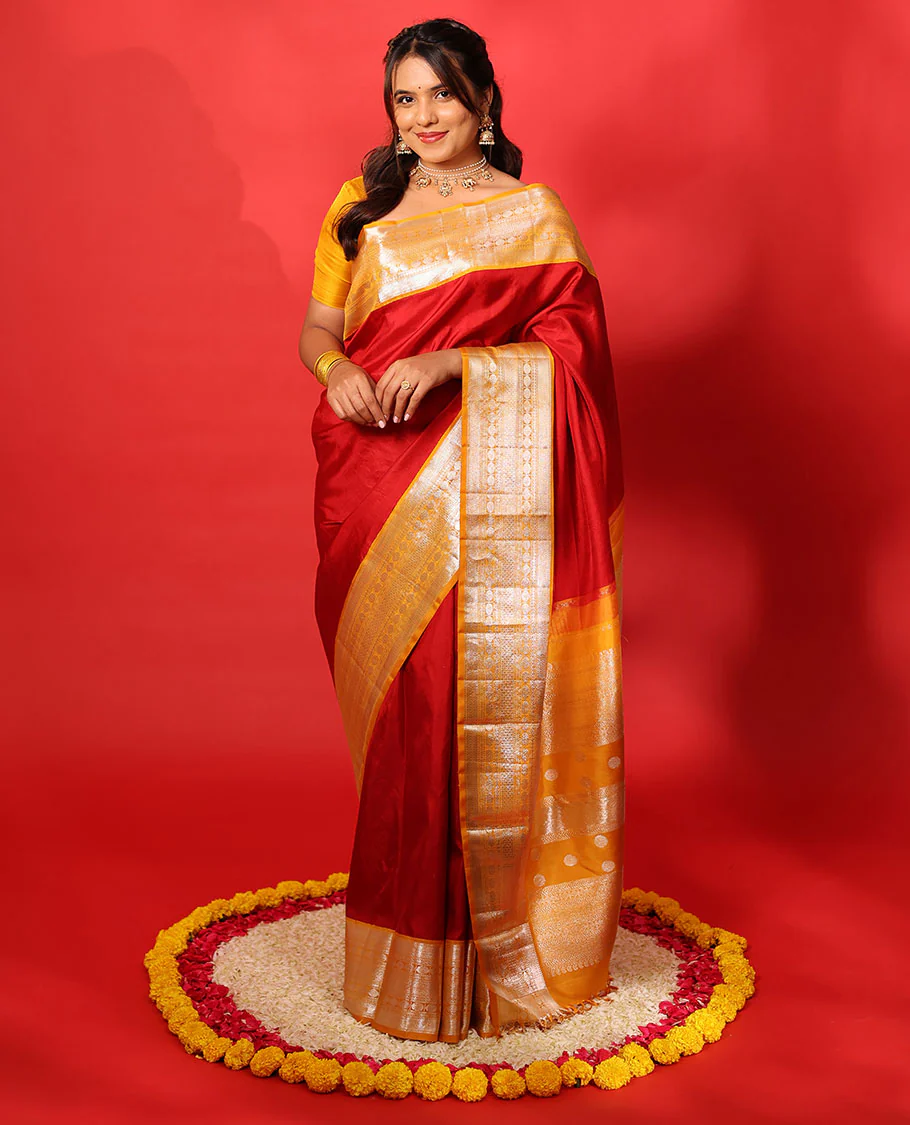 Red plain Kanchipuram silk saree, contrast korvai border of muthu, vanki, neli, rudraksham, and mayil kann, and traditional zari steeped pallu