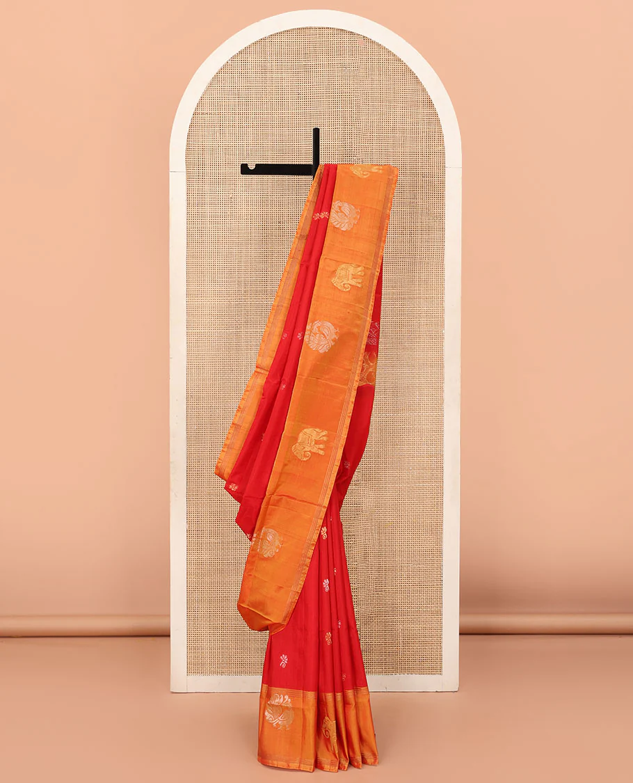 Red Uppada Silk Saree Decorated with Zari Buttas, Captivating Contrast Border Featuring Peacock and Elephant Motifs in Zari, Pallu Adorned with Paisley Butta, Enclosed Jaal Design, and Paired with a Contrast Blouse
