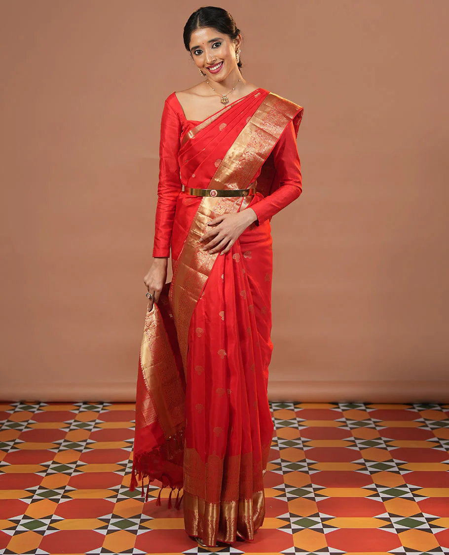 Red zari buttas and mamallapuram temple motifs zari woven silk saree, zari border of salangi, muthu, banaras, mayil, and lavangam designs, and intricate pallu
