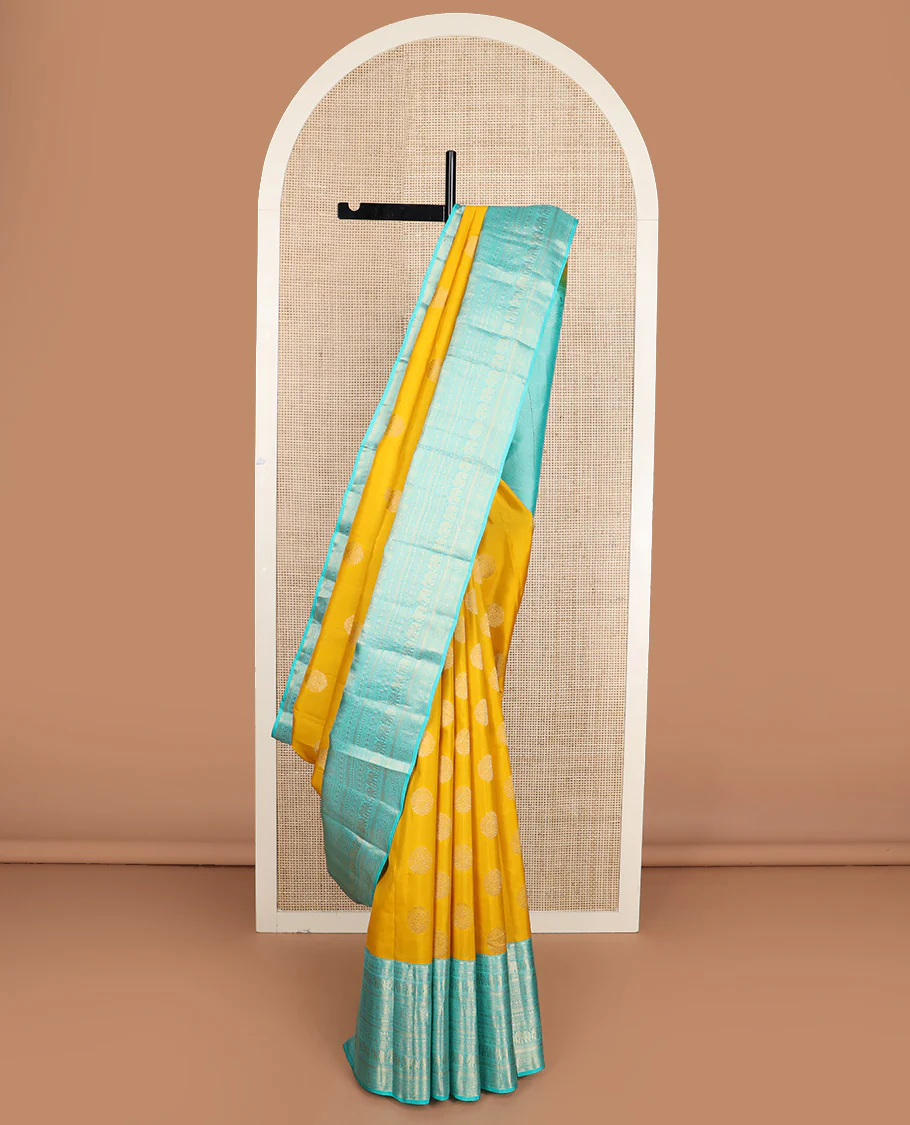 Yellow zari buttas Vasundhara silk saree, contrast border of thilakam mokku, poun, yaanai, chakram, and mayil kann designs, and jaal pallu - Image 2