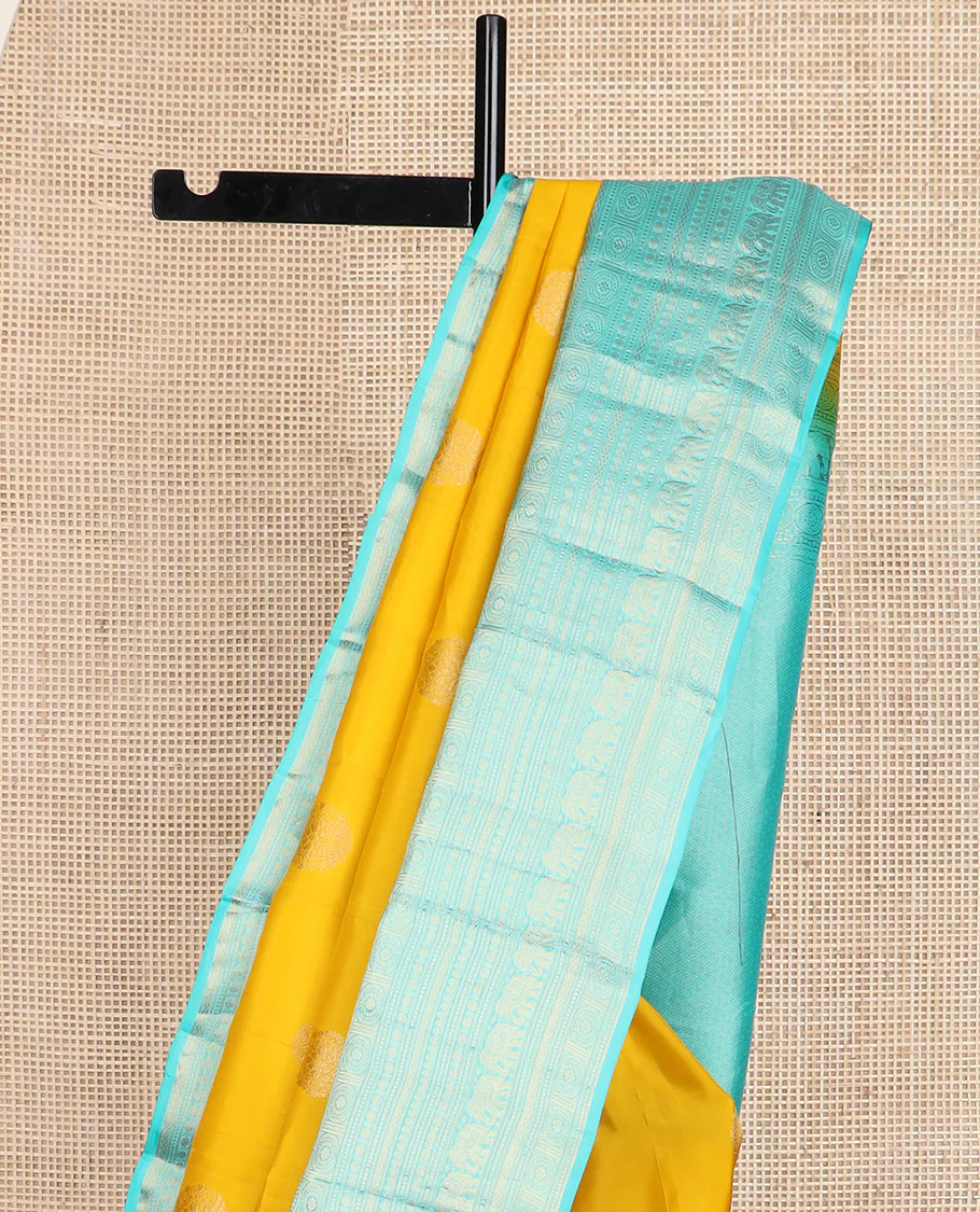 Yellow zari buttas Vasundhara silk saree, contrast border of thilakam mokku, poun, yaanai, chakram, and mayil kann designs, and jaal pallu - Image 4