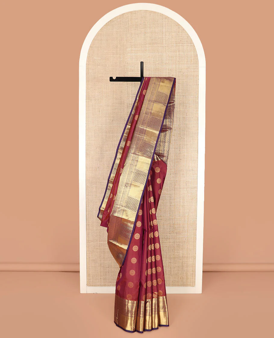 Rosewood Red Vasundhara Silk Saree Spotlighted with Chakram Buttas, Highlighted with a Contrast Border of Rekku, Muthu, Mayil Kann, and Jaal Designs, Pallu Majestically Detailed with Jaal Design, and Paired with a Contrast Blouse