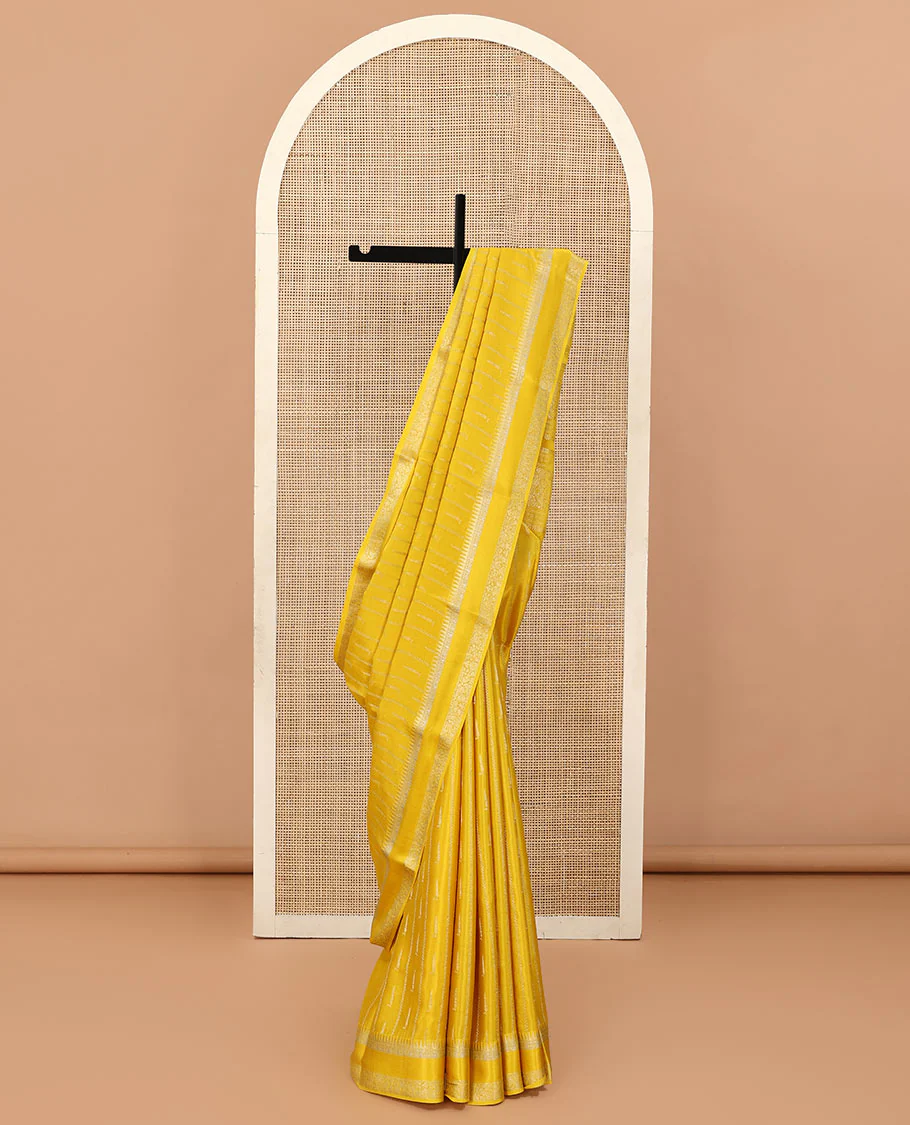 Sandal zari buttas and zig-zag striped crepe saree, traditional zari border, and pallu of traditional design weave