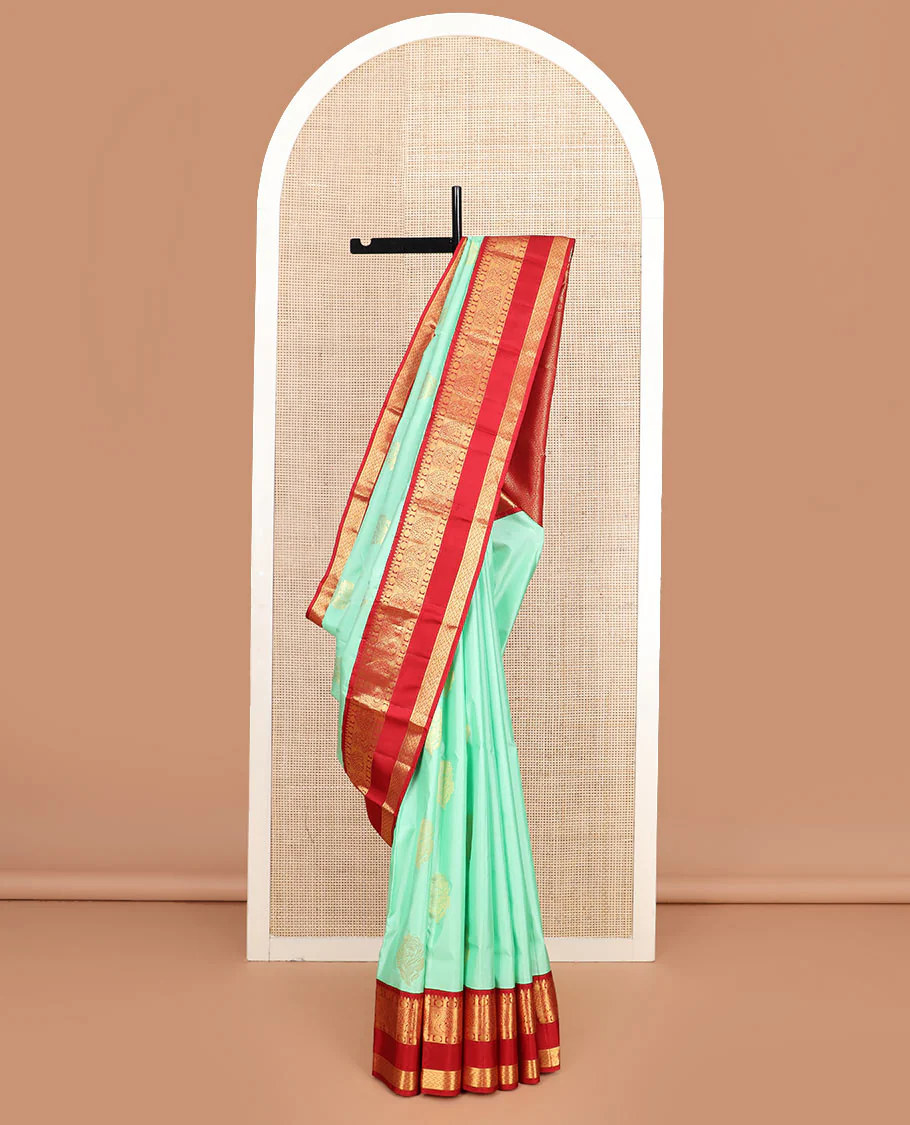 Sea green zari buttas Vasundhara silk saree, contrast korvai rettai pettu border of thilakam, mayil kann, rudraksham, and vanki designs, and jaal pallu