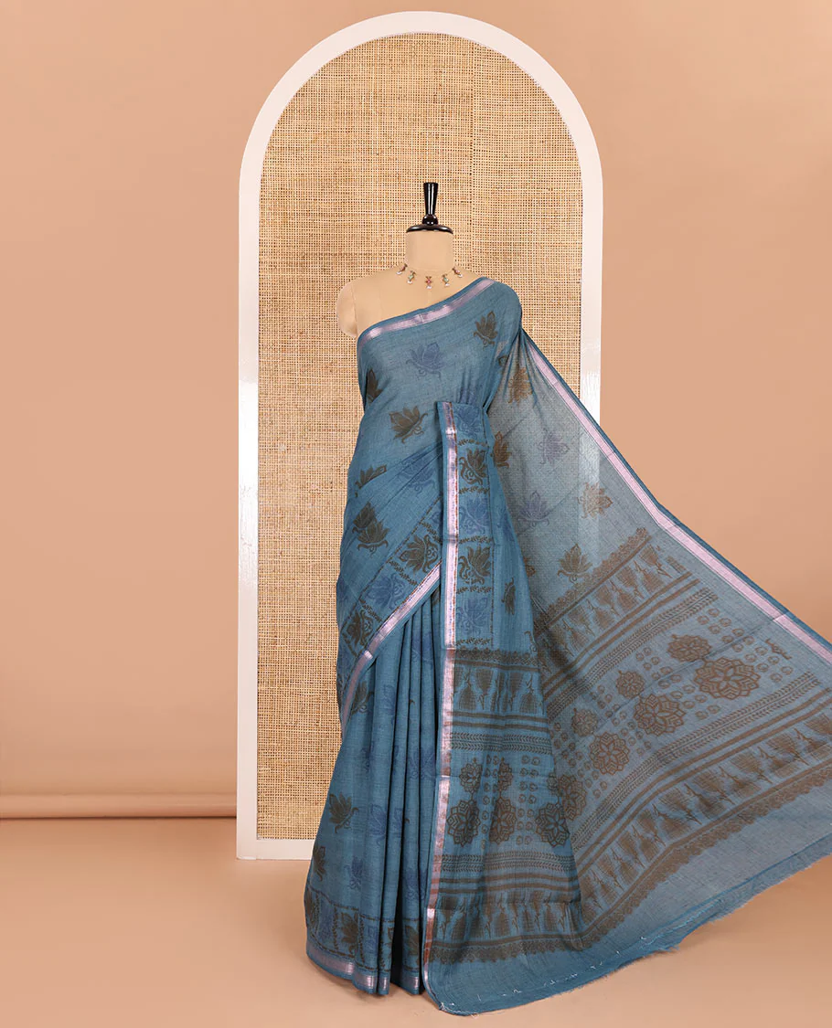 Sky blue lotus printed soft cotton saree, piping border, printed pallu, and a shibori printed blouse of polka dots