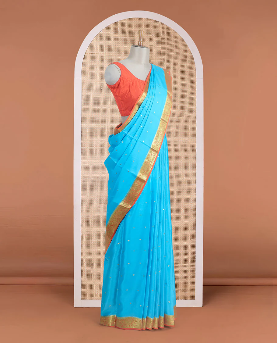 Sky blue zari buttas Mysore silk saree, contrast leaf creeper zari border, and floral zari design palllu