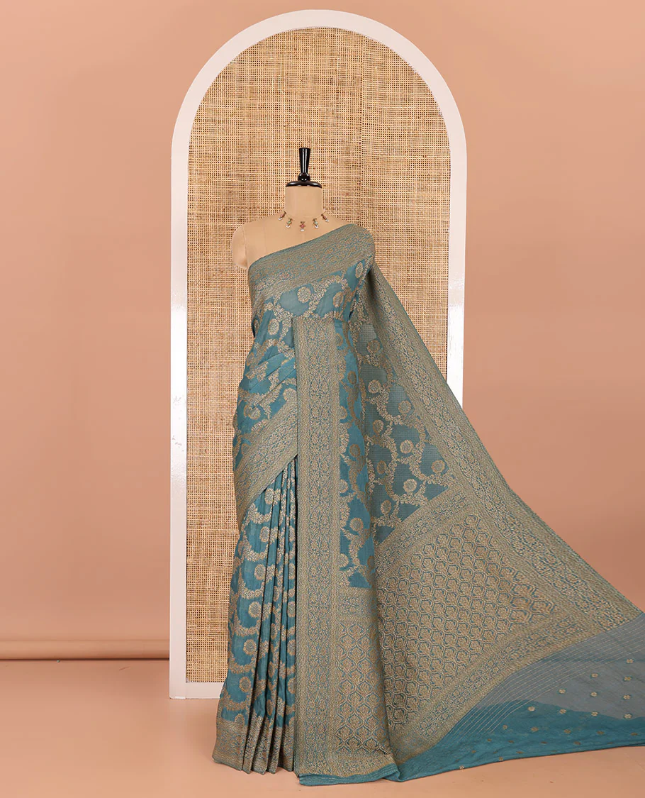 Teal blue jaal jacquard fancy crepe banaras khaddi saree, floral creeper design border, ogee patterned pallu, and a matching blouse