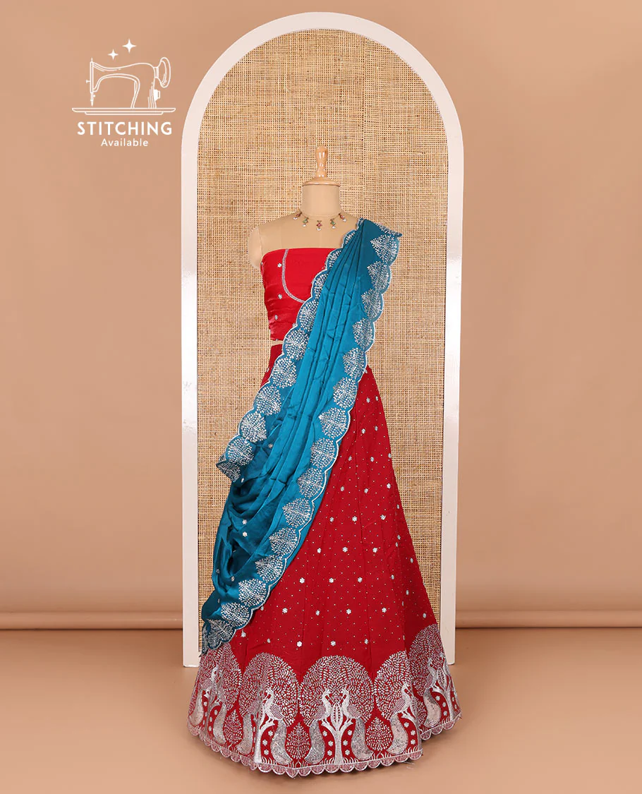 Tomato red half-saree, buttas, tree, and peacock motifs embroidered semi-taffeta silk top, matching blouse, and contrast scallop embroidered dhavani
