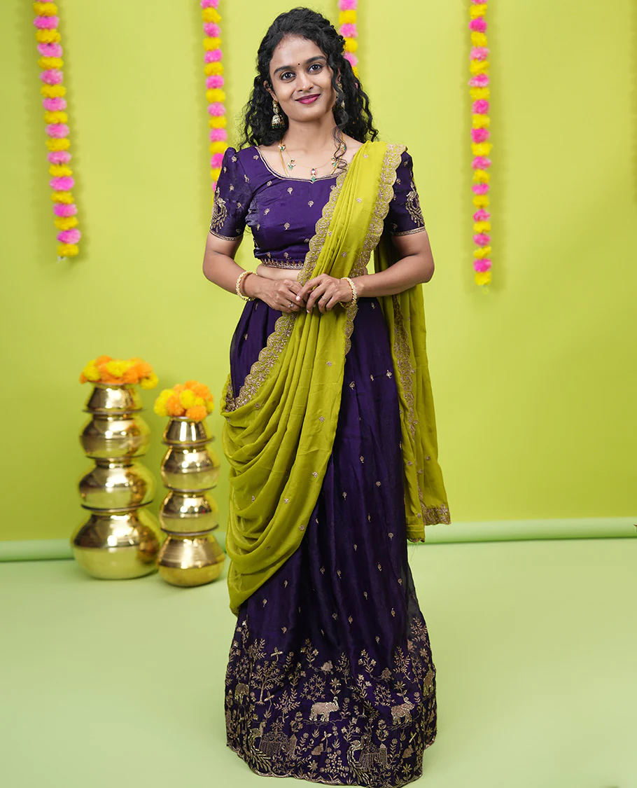 Violet half-saree, buttas and flora-fauna embroidered bordered velvet organza skirt, a matching velvet organza blouse, and a contrast embroidered scallop syska georgette dhavanif
