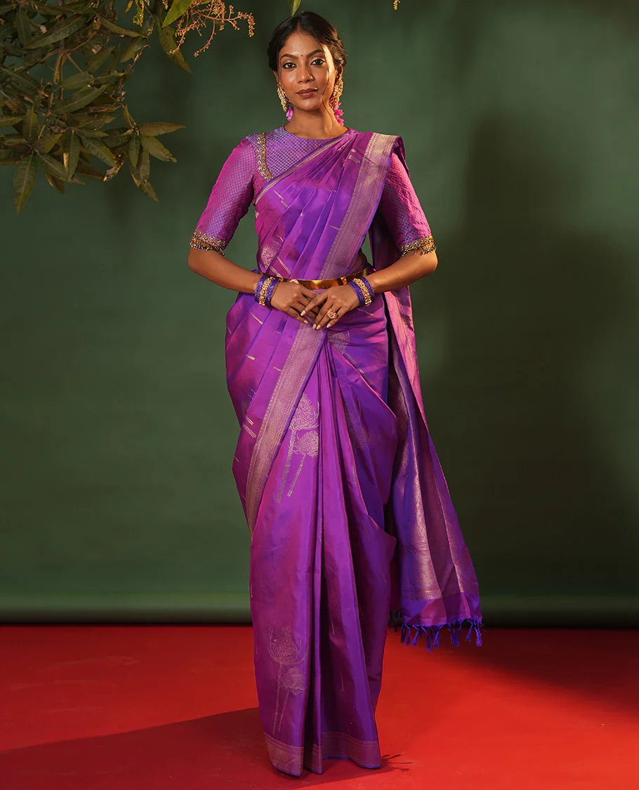 Violet thazampoo rekku, and vel buttas Vasundhara silk saree, zari border of manga, muthu, kathir, neli, and vanki designs, and jaal pallu