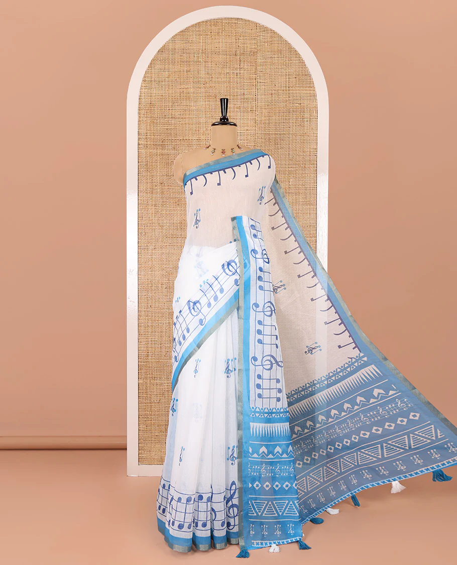 White and blue musical note motifs printed Chanderi cotton saree, zari piping border, geometric printed pallu, and a unique motifs printed blouse