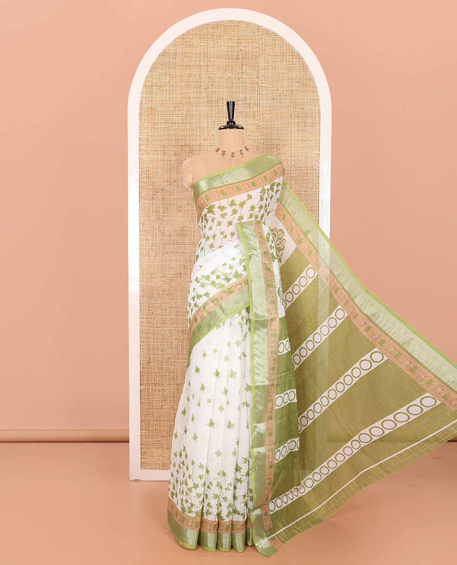 White and Green Linen Cotton Saree Featuring Field Maple Leaf Motifs Printed All Over the Body, Complemented by a Contrast Zari and Peacock-Printed Border, Pallu of Geometric Print, and Paired with a Contrast Checked Blouse