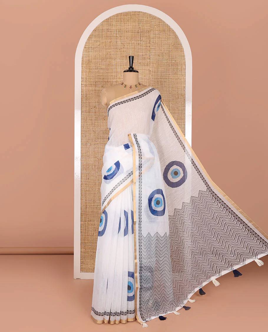 White evil eye motifs printed linen cotton saree, diamond motifs printed with piping border, chevron printed pallu, and a matching blouse