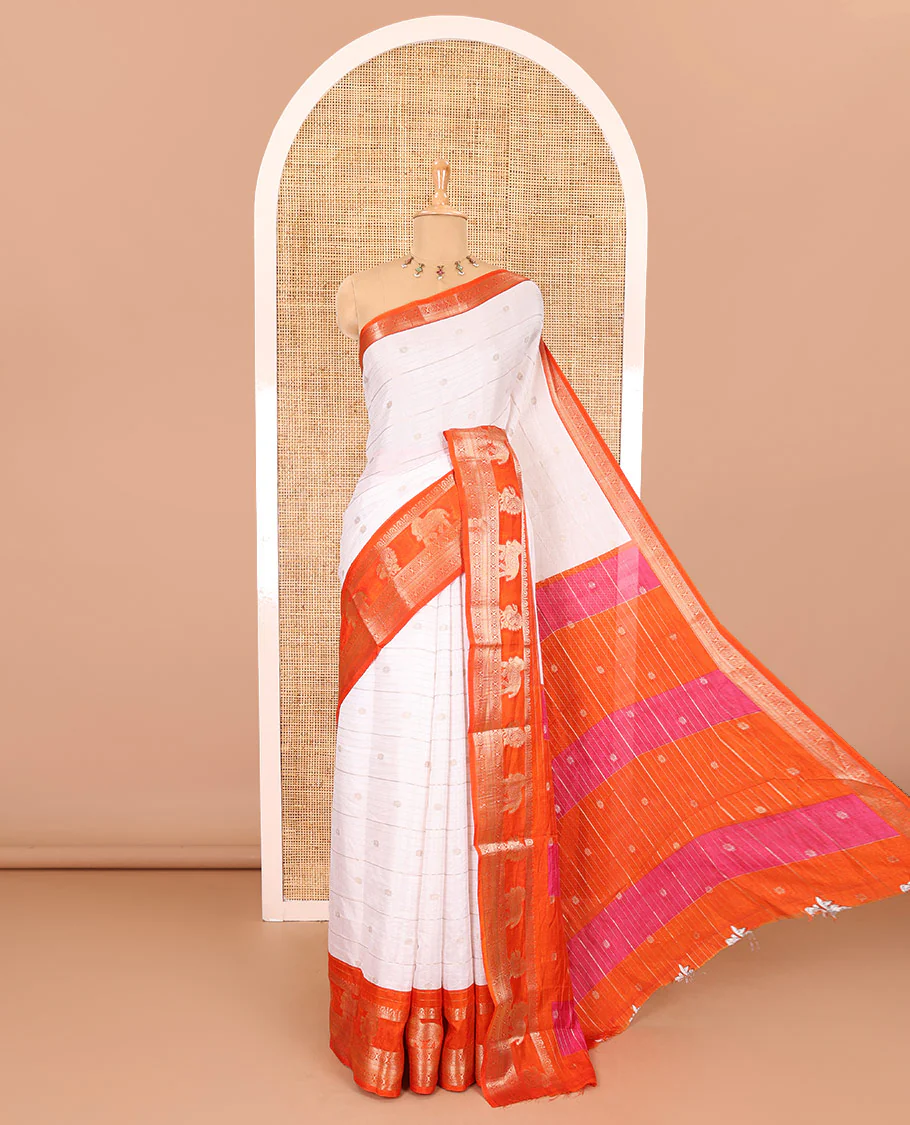 White zari buttas and striped dola silk saree, contrast traditional zari border of elephant and peacock buttas, zari design pallu, and a contrast floral print with zari work blouse