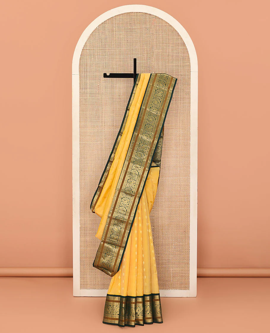 Yellow buttas Bangalore silk saree, contrast traditional zari border of peacocks, and pallu steeped with floral designs
