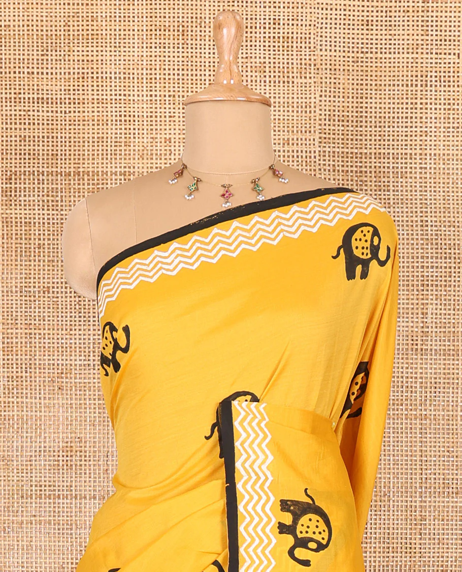 Yellow elephant motifs block printed South cotton saree, chevron stripes block printed border, a matching blouse, and a contrast floral vine printed blouse - Image 3