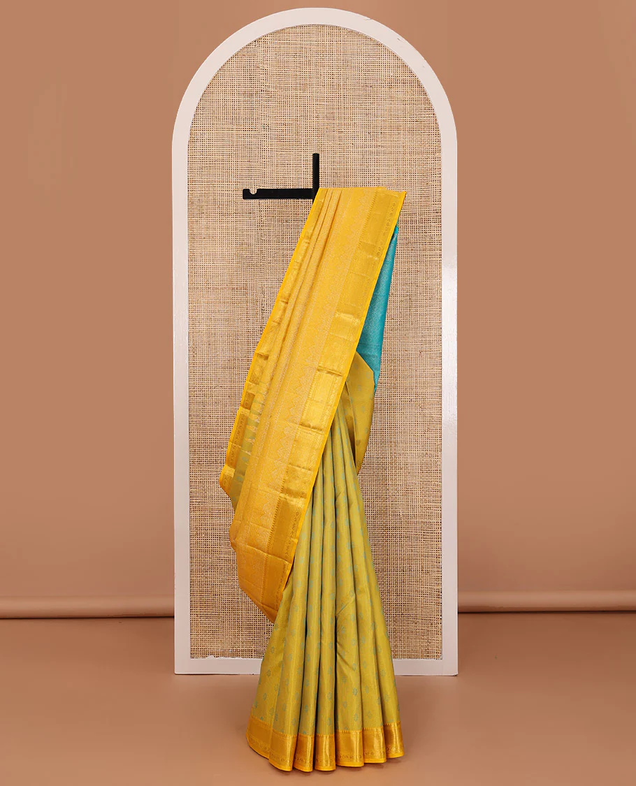 Yellow embossed Parampara silk saree, contrast border of thilakam mokku, muthu, ara bogudi, and kuyil kann, and jaal pallu
