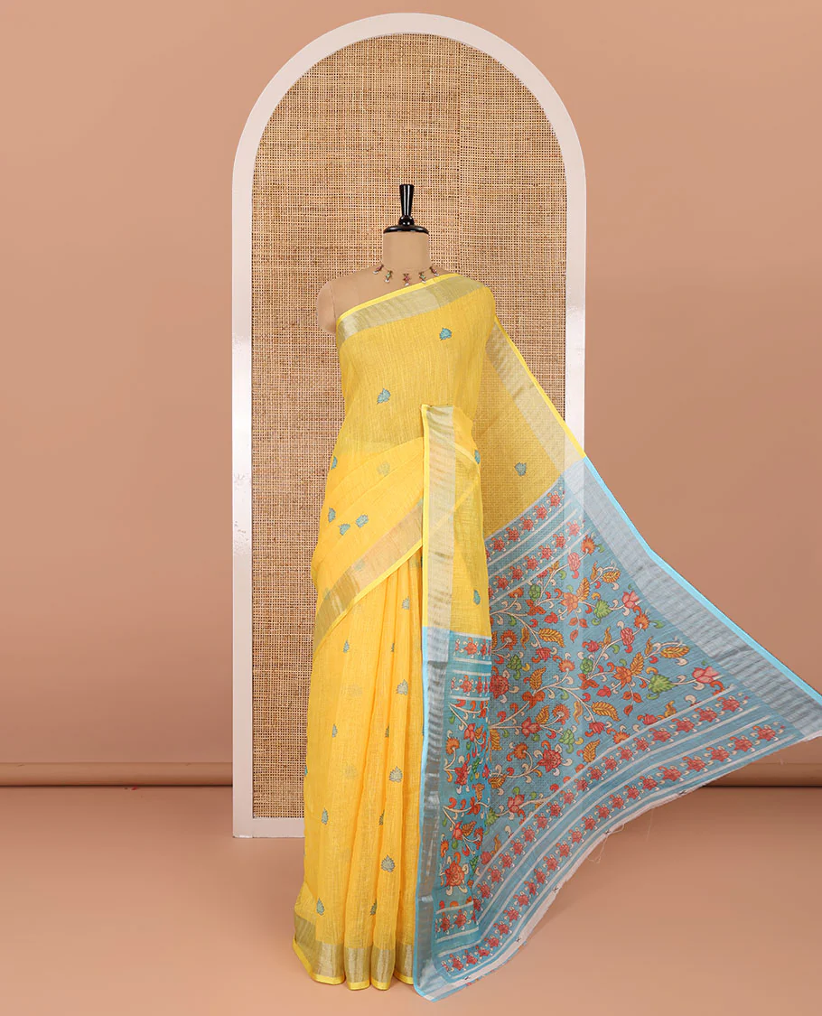 Yellow floral buttas printed linen cotton saree, zari border, contrast kalamkari floral vine printed pallu, and kalamkari floral vine printed blouse