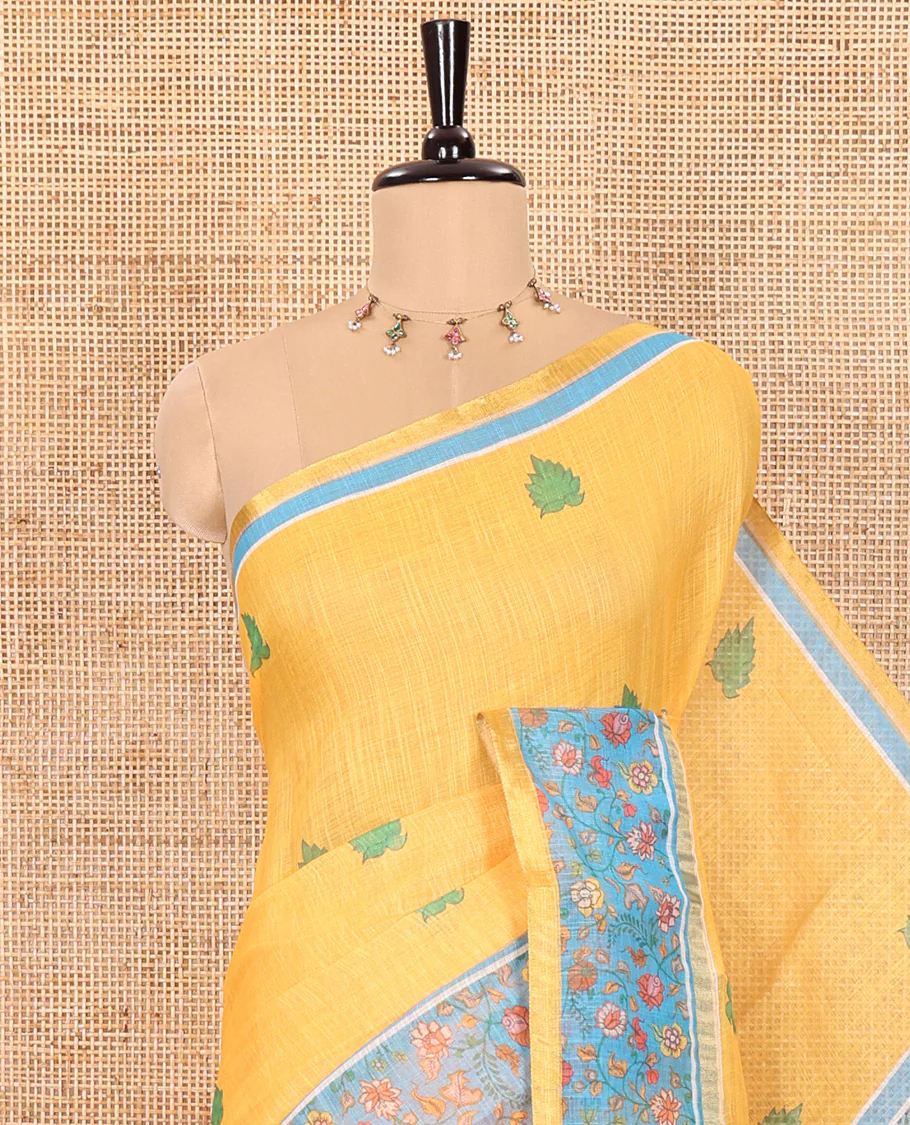 Yellow Linen Saree Detailed with Leaf Motifs All Over Its Body, Complemented by a Contrast Floral Vine Printed Border, Pallu Mirrors the Floral Vine Print, and Paired with a Contrast Floral Printed Blouse - Image 2