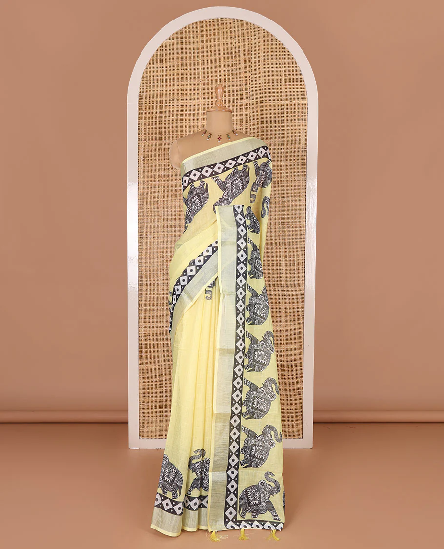 Yellow plain linen cotton saree, silver zari border of elephant motifs print, elephant motifs pallu, and a contrast elephant motifs printed blouse - Image 2