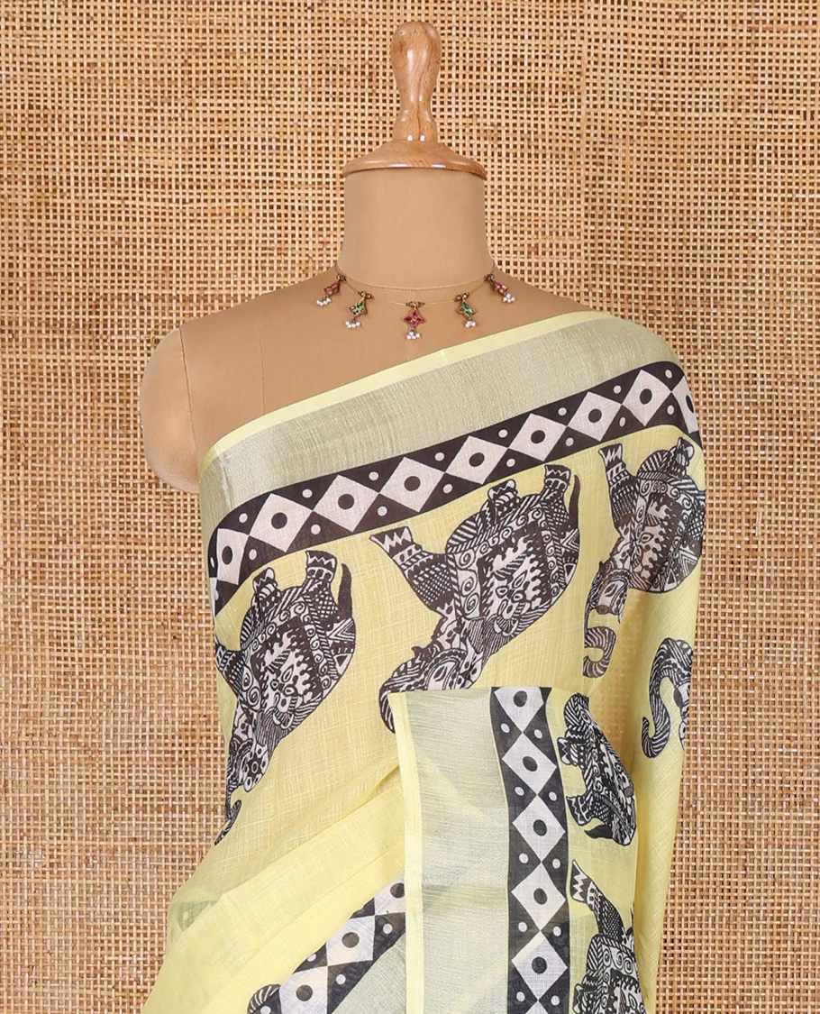 Yellow plain linen cotton saree, silver zari border of elephant motifs print, elephant motifs pallu, and a contrast elephant motifs printed blouse - Image 3