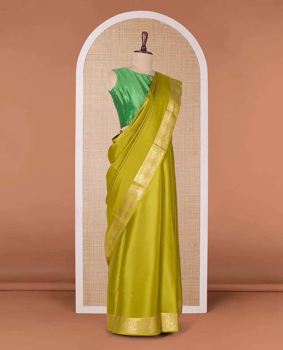 Green plain Mysore silk saree, zari border of two-headed eagle motifs, and pallu of zari designs