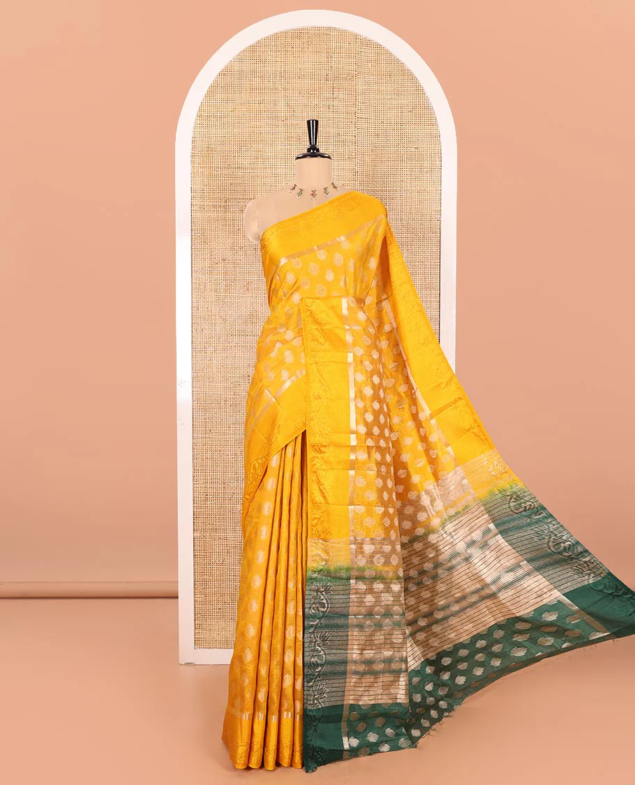 Yellow Semi-Tussar Saree Ornamented with Copper Zari Floral Bud Motifs, Featuring a Floral Creeper Embossed Border, Complemented by a Contrast Pallu Adorned with Floral Bud Motifs, and Paired with a Contrast Blouse