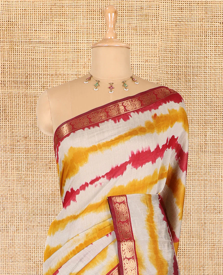 Yellow shibori printed muslin cotton saree, contrast peacock zari border, village scenery printed pallu, and a contrast polka dotted zari border blouse - Image 3