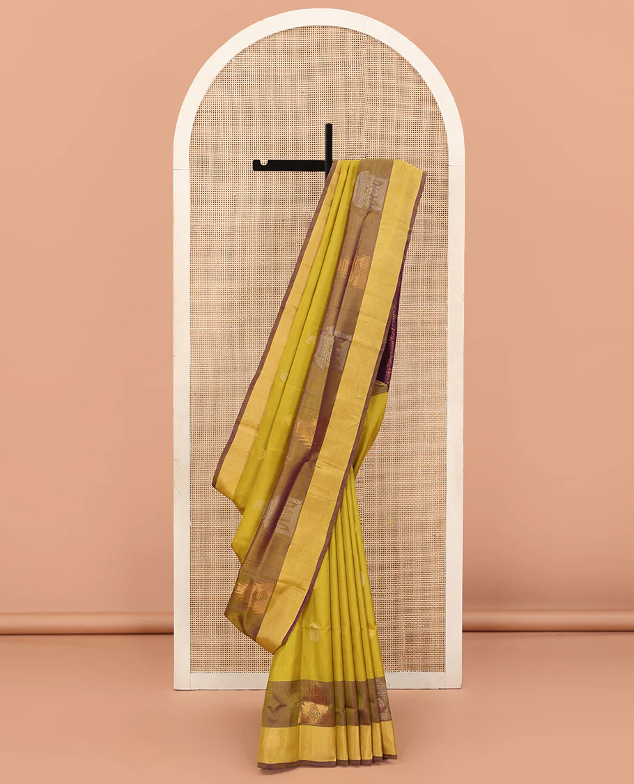 Yellow Uppada Silk Saree Decked Up with Paisley Buttas, Subtle Contrast Border of Temple Gopuram Motifs, Captivating Pallu Featuring Floral Jaal Design, and Paired with a Contrast Blouse