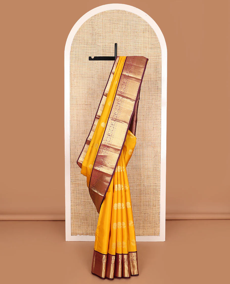 Yellow Vasundhara Lite Silk Mix Saree Dazzled with Zari Buttas, Complemented by a Contrast Border Featuring Rekku, Diamond, Muthu, Mayil, Kamalam, and Mayil Kann Designs, and Zari Elevated Jaal Pallu, and a Contrast Blouse