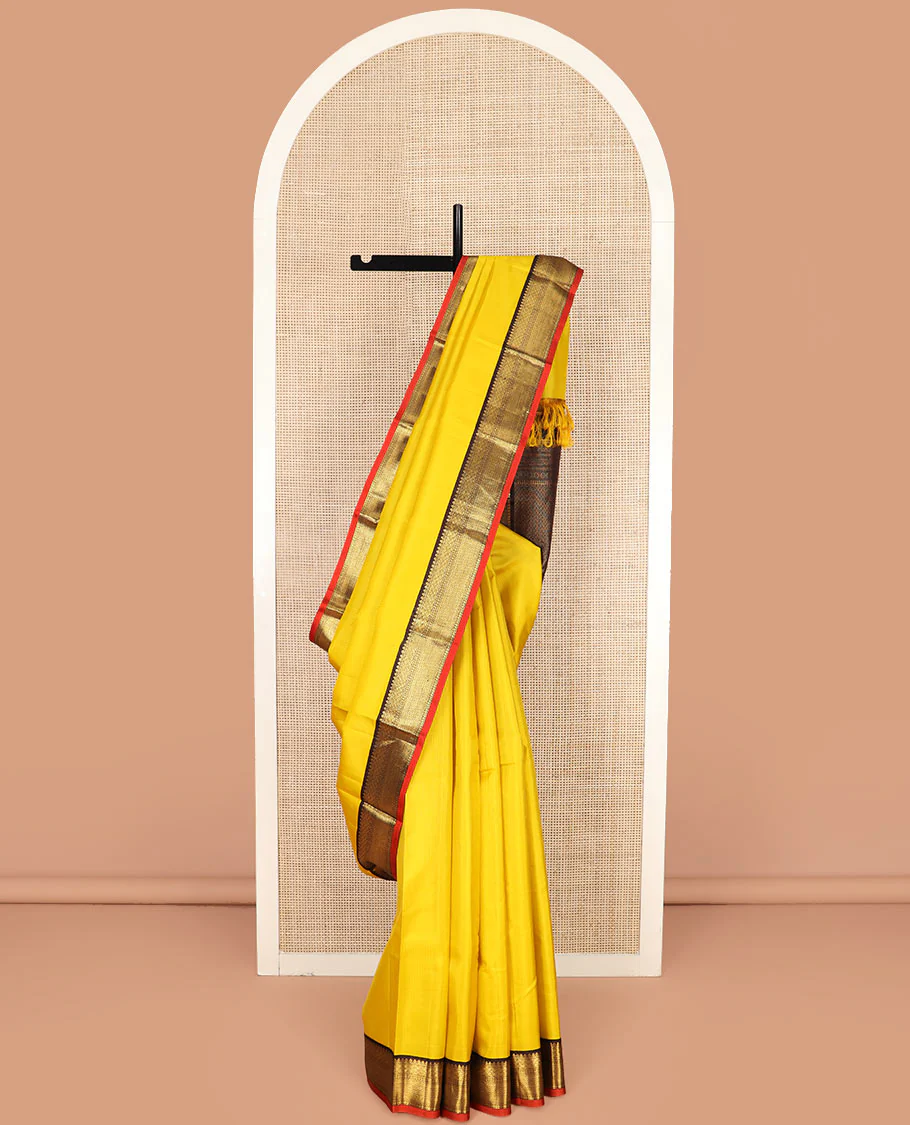 Yellow Vasundhara Silk Saree Subtly Woven in Stripes, Complemented with a Contrast Border Featuring Paiyaadi Kann, Neli, and Mayil Kann Design, Subtly Woven Pallu of Intricate Designs, and Paired with a Contrast Blouse