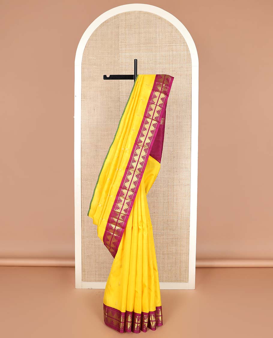 Yellow zari buttas Kanchipuram silk saree, contrast thazampoo rekku border, and zari design pallu