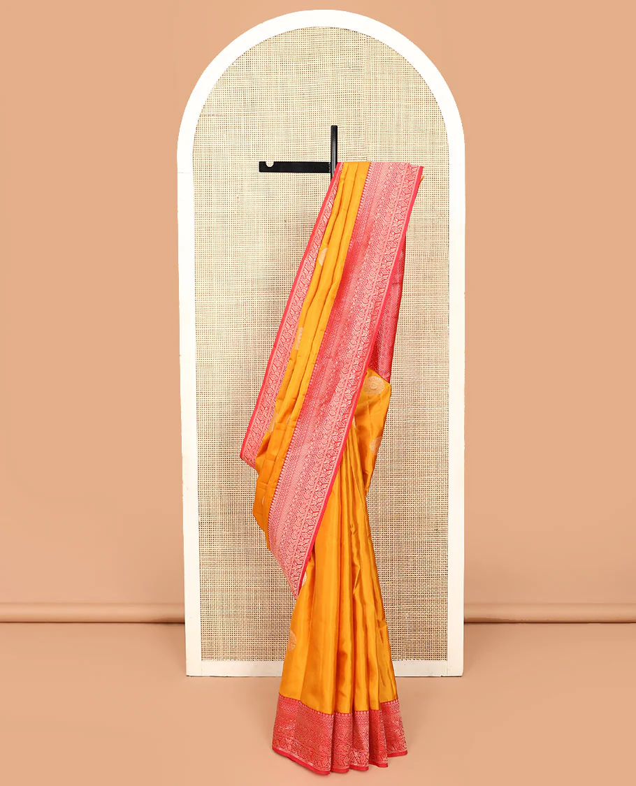Yellow zari buttas Vasundhara silk saree, contrast border of thilakam mokku, kathir, leaf vine, floral, and diamond designs, and pallu of intricate designs